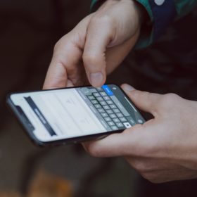 selective focus photography of person using smartphone